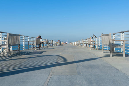 Hermosa Beach USA - October 7 2015; People relaxing, fishing walking on Hermosa Pier on clear summer...