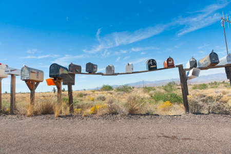 Row of letterboxes on sagging plank at intersection of rural road and Route 66, Arizona, USAのeditorial素材