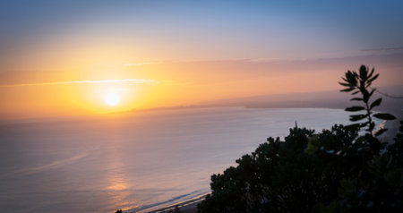 Abstract gradient sky color with rising sun on distant horizon is a metaphor for looking to the...