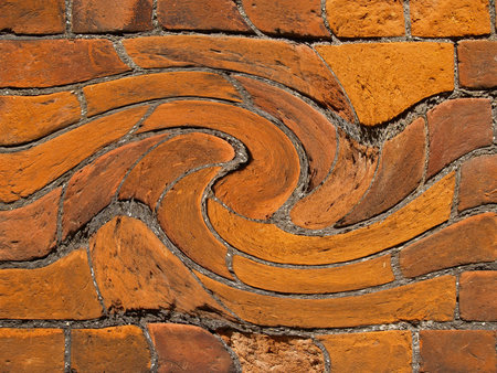 Swirling  imaginative style path like tattern through bricks in wall.