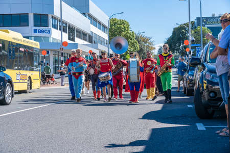 Tauranga New Zealand - April 3 2021; Superhero Band marching along city street past buildings and people during National Jazz Festivalのeditorial素材