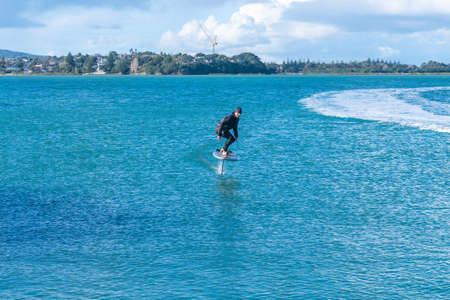 Auckland New Zealand - June 17 2021;Foil board being towed behind jet-ski on Auckland harbor Stanley Bayの写真素材