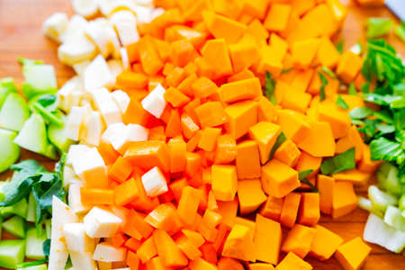 Chopped and prepared vegetables on kitchen board ready to be cooked and made into soup.の写真素材
