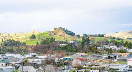 Te Kuiti New Zealand - July 26 2021; rooftops and landscape on the main trunk line of Kiwi Rail's Northern Explorer tourist train en-route Auckland to Wellington.のeditorial素材