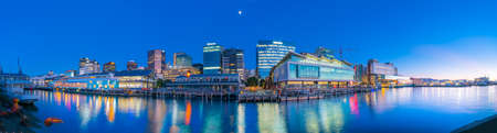 Wellington New Zealand _ July 28 2021;Wellington skyline at night from wharf with city lights, signs and reflections on habrour.のeditorial素材