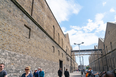 Dublin, IRELAND - AUGUST 9 2017; Guinness storehouse complex from street with tourists arriving and...