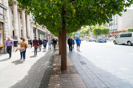 Dublin, IRELAND - AUGUST 9 2017; people walking in treed street in city business district with GPO building.のeditorial素材