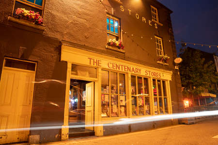 Wexford Ireland - August 14 2017; The Centenary Stores restaurant and bar building catching night lights in long exposure with passing vehicles light streams.のeditorial素材