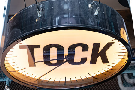 Dublin, IRELAND - AUGUST 9 2017; Clock face orange in color with hands and large word TOCK