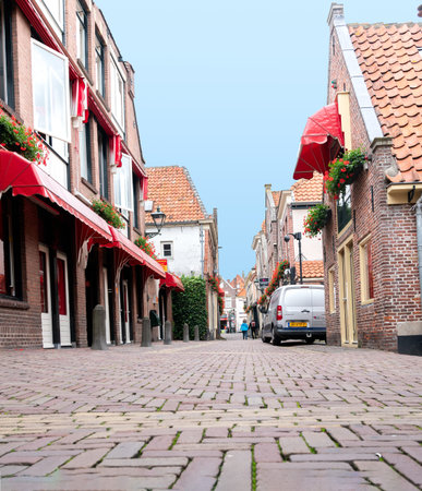 Alkmaar Netherlands - August 18 2012; Quiet picturesque cobbled street with brick and tile buildings...