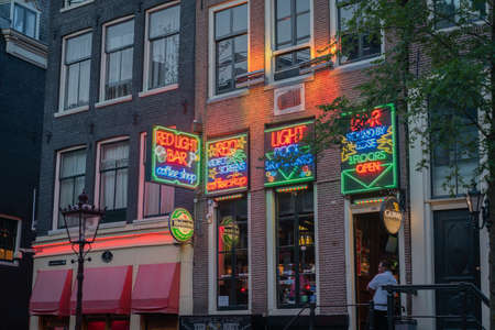 Amsterdam Netherlands - August 17 2017; Building exterior entrance and bright neon light sign for Red Light Bar in city at night.1のeditorial素材