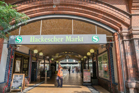 Berlin, Germany - August 27 2017; Man in high-vis vest in entrance to popular location Hackescher Marktのeditorial素材