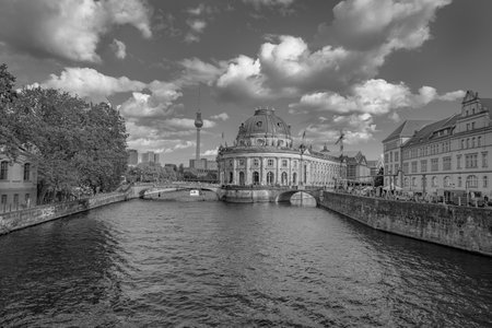 Berlin, Germany - August 28 2017; old-fashioned effect in monochrome of River Spree leading to famous shape of frontage of Bode Museum with tourist river boats and surrounding building.のeditorial素材
