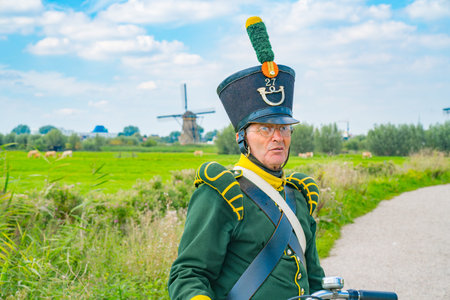 Kinderdijk Netherlands - August 22 2017; Man on bike dressed in traditional costume in Kinderdijk....