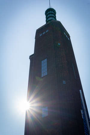 Rotterdam Holland - August 23 2017; Back-lit by sun in silhouette 1930s Brick & glass tower of the Museum Boijmans Van Beuningen in Rotterdam, Netherlands. architectural landmark.のeditorial素材