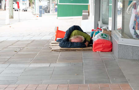Tauranga new Zealand - December 7 2021; Rough sleeping middle-aged man on city street typifies a growing social issue.のeditorial素材