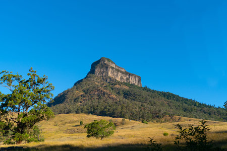 Huge sheer faced rock in Queensland landscape, Australia.
