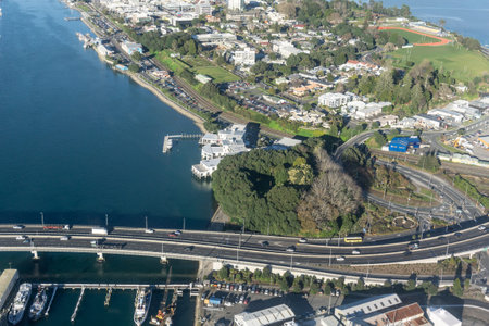 Aerial image of part of Tauranga city with buildings, parks and off and on ramps of Tauranga Harbour...