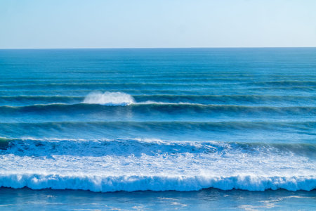 Cyclone Cody large waves and swells rolling in from horizon at Mount Maunganui, New Zealand.