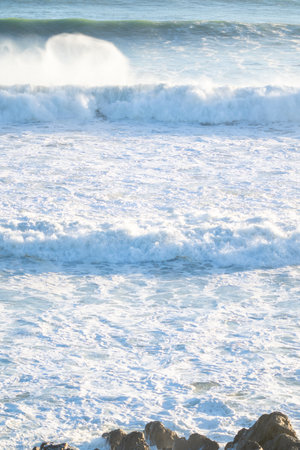 Waves rolling in from horizon at Mount Maunganui.の写真素材