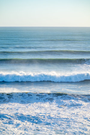 Waves rolling in from horizon at Mount Maunganui.の写真素材
