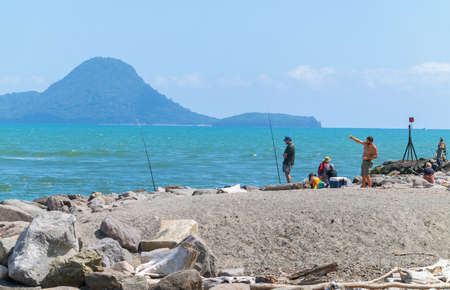 Whakatane New Zealand - January 30 2022; Fishers trying their luck on rock groyne at Whakatane Heads.のeditorial素材
