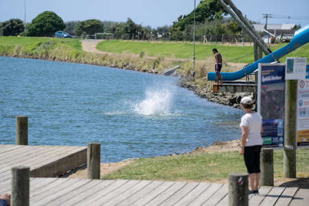 Opotiki New Zealand - january 30 2022; Young people jumping into Waioeka River enjoying summer funのeditorial素材