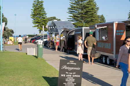Tauranga New Zealand - April 3 2022; Food and drink vendor vans and people on Mount Maunganui's...
