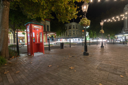 Whanganui New Zealand - April 9 2022; City downtown street scene at night with traditional red telephone boot,illuminated by street lamps.のeditorial素材