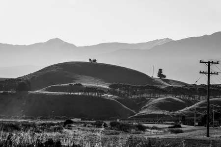 Landscape view towards Kaikoura Seaward mountains from lookout in hazy evening light.の写真素材