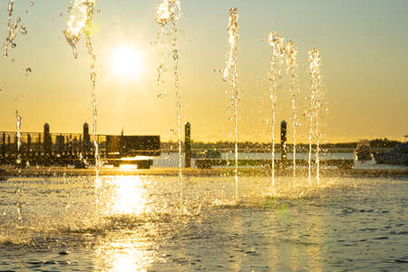 Water feature spraying waters in morning light on Tauranga Strand waterfrontの写真素材