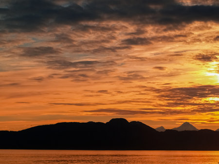 Sunset and silhouette distant hills and land in Alaskan travel image.の写真素材