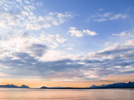 Sunset and silhouette distant hills and land in Alaskan travel image.の写真素材