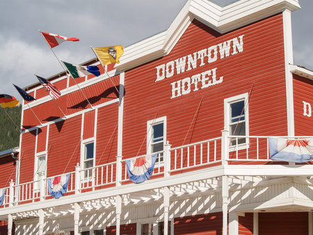 Dawson City Yukon Territory, Canada - August 4 2008; Exterior of city building with sign reading Downtown Hotel in white on red.のeditorial素材