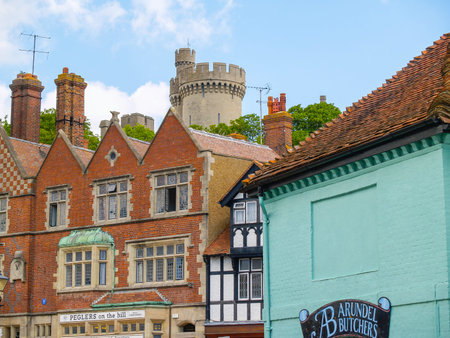 Arundel United Kingdom - June 16 2009; Arundel urban street with castle behind apartments and shop...