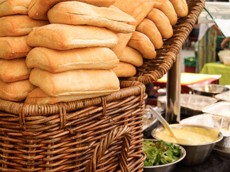 Artisan bread buns stacked in basket in Saturday market in London United Kingdom.の写真素材