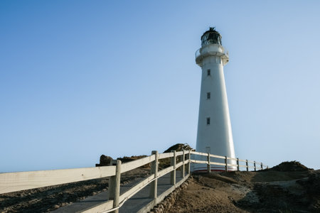 Path and railing leading to Castle Point Lighthouse and coastline on Wairarapa coast in New Zealand.のeditorial素材