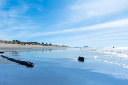 View along Papamoa beach to landmark Mount Maunganui in distance.の写真素材