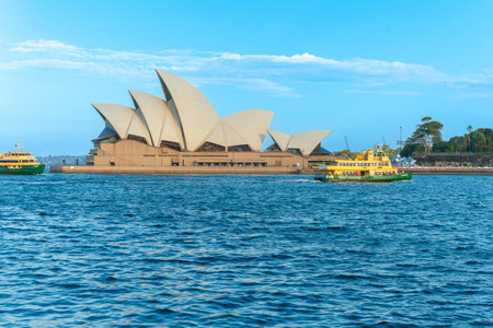 Sydney Australia - January 26 2011; Harbour ferries pass recognizable design of Sydney Opera Houseのeditorial素材