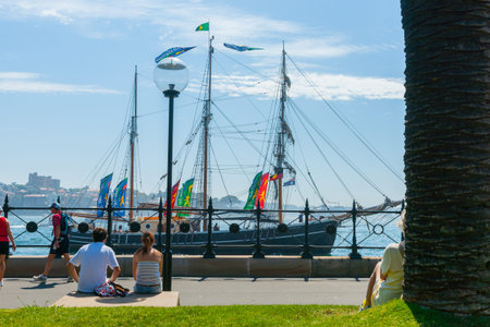 Sydney Australia - January 27 2011; People sitting by city waterfront watching old vessel Southern...