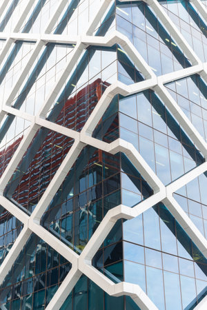 Sydney Australia - January 27 2011; Unusual structural white diagonal beams mesh around glass exterior of modern office buildingのeditorial素材