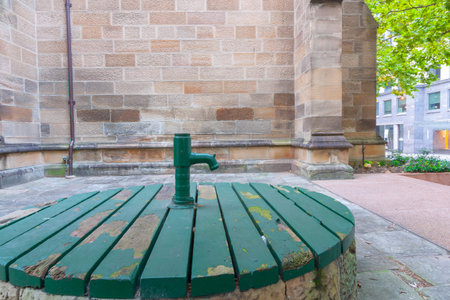 Old dry street well in Rocks district painted green and retained for it's heritage value.