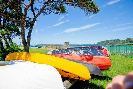 Upturned colourful dinghy and kayak near Northland beachの写真素材