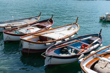 Portovenere Italy - April 27 2011; Fishing boats moored together on coast of Italian fishing village.のeditorial素材