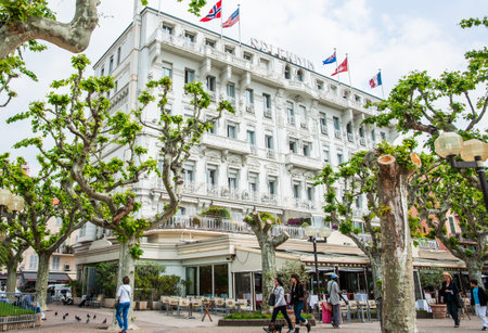 Cannes France - April 29 2011; Splendid Hotel building on rue Felix Faure and architecturally pruned London Plane trees.のeditorial素材