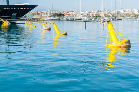 Yellow mooring buoys blue luxury boat bow in marina at Port Vauban, Antibes, France.の写真素材