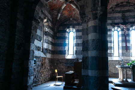 sunlight through clerestory windows illuminate Chapel and prayer room.and small chapel in Romanesque style Church of Saint Peter in Portovenere, Italy.のeditorial素材