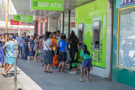 Sigatoka Fiji -September 8 2023; Long queue or line of people in street queuing outside ATM to get...
