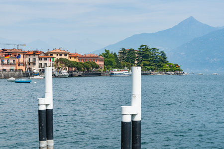 Menaggio Italy - May 7 2011; scenic Lake Como from pier to buildings with mountain background.のeditorial素材