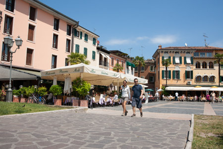 Sermione Italy -May 9 2011; Italian city town square with surrounding buildings, bars and restaurants.のeditorial素材